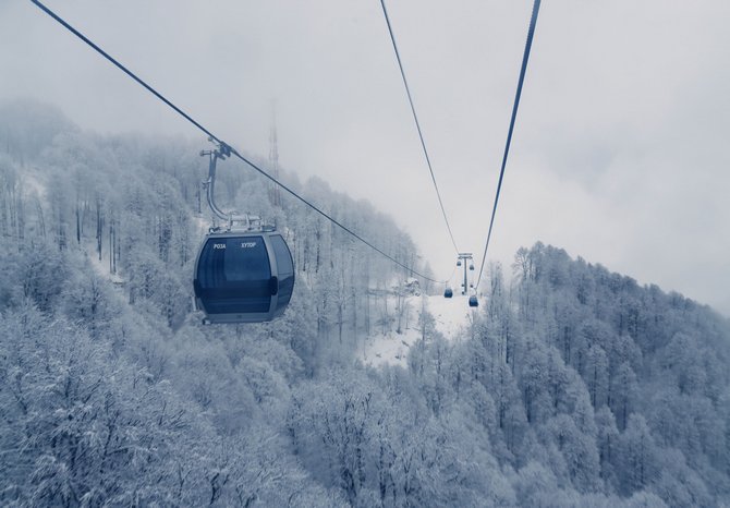 The town of  Rosa Khutor, Russia is covered in fog below as viewed from a descending gondola